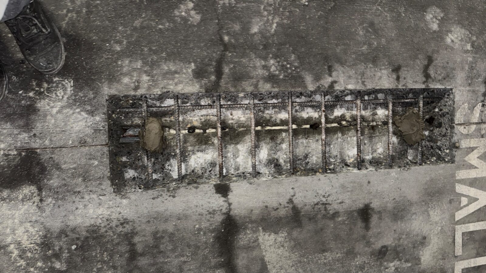 Exposed reinforcing steel during parkade concrete repair